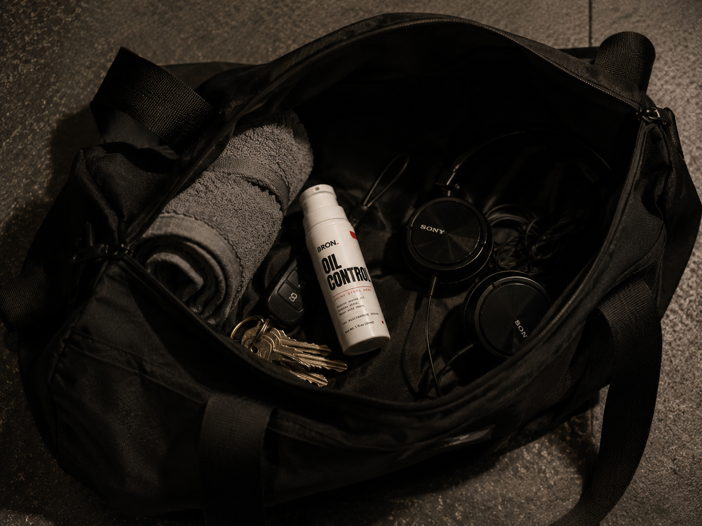 BRON Oil Control bottle in an open gym bag