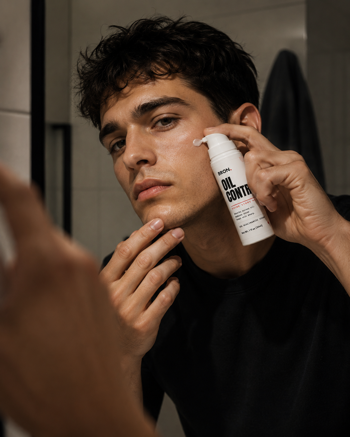 Man applying BRON Oil Control serum at the bathroom mirror