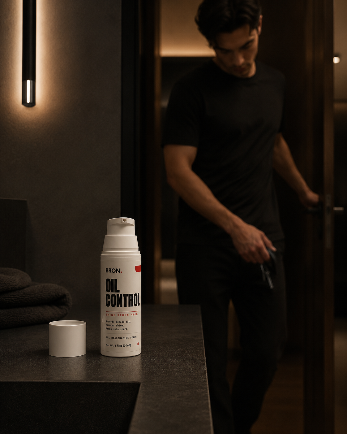 Man leaving the bathroom, bottle on the counter